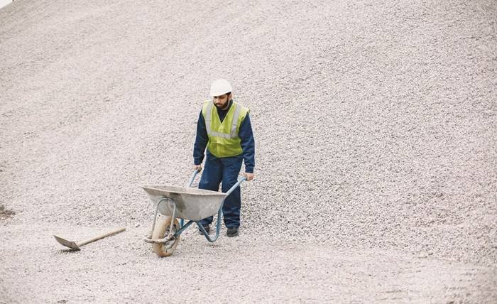 Mastering Curb Appeal: The Allure of Exposed Aggregate indian man working male yellow vest man with wheelbarrow 1157 47553