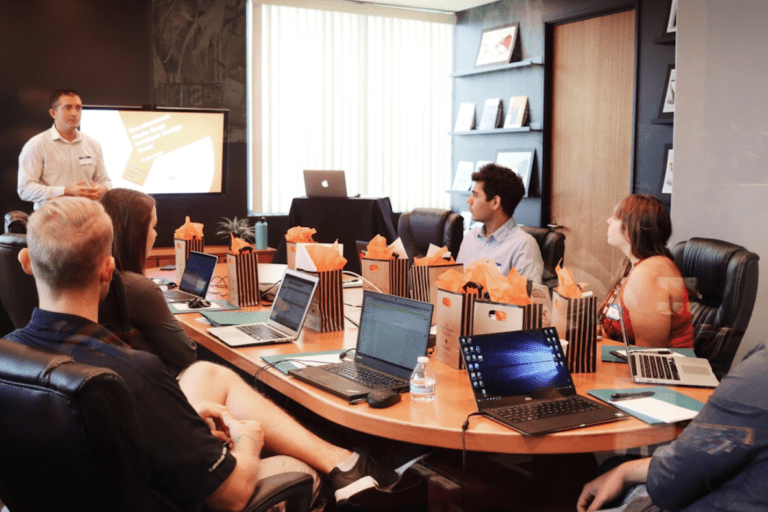 Team members engaged in a meeting discussing opportunity management and its role in driving business growth